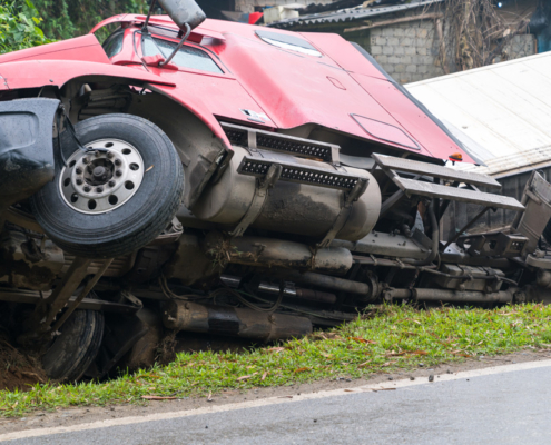 Truck overturned and lying in ditch on side