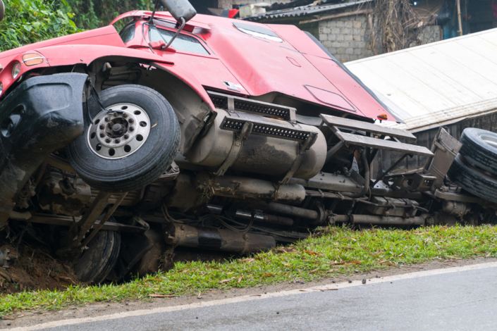 Truck overturned and lying in ditch on side