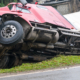 Truck overturned and lying in ditch on side