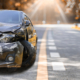Artumn road. Front of black color car big damaged and broken by accident on road parking can not drive any more. With copy space for text or design