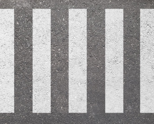 crosswalk on the road for safety when people walking cross the street.