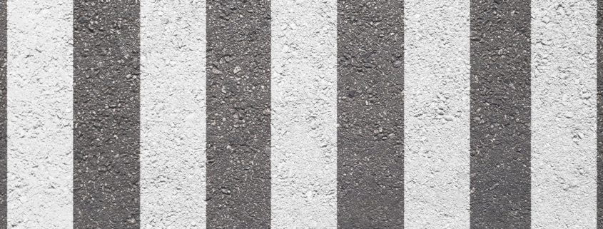 crosswalk on the road for safety when people walking cross the street.