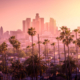 Beautiful sunset of Los Angeles downtown skyline and palm trees