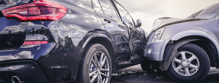 Car crash dangerous accident on the road. SUV car crashing beside another one on the road.