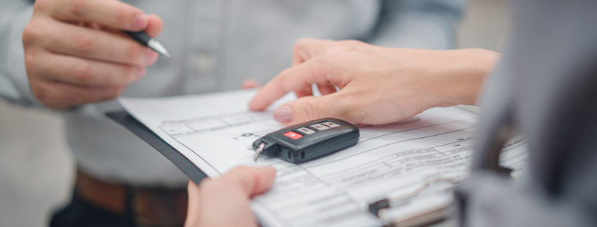 Car sale or rental concept, Closeup Dealership manager signing car insurance document or lease paper contract. Customer with car dealer agent making deal, sign on agreement document contract in office