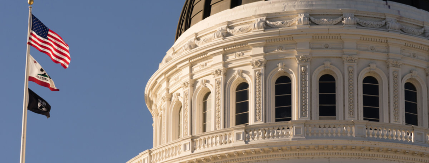 The flags fly in front of Sacramento's Capital Building