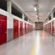 Long row of red color doors of self storage facility. Service to keep safe extra belongings. Nobody. Selective focus. Clean and well run business.