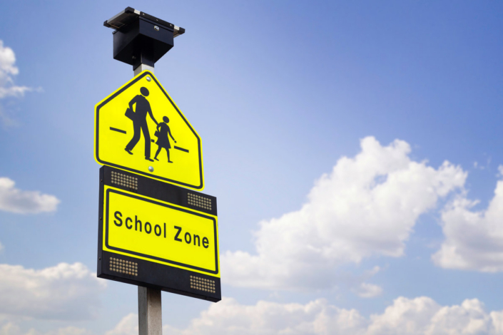 school zone label on blue sky background