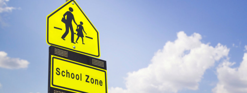 school zone label on blue sky background