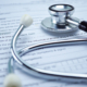 Health insurance accident claim form with stethoscope on desk