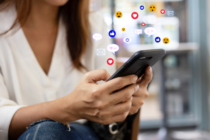 Woman sitting in a coffee shop using a smartphone