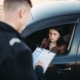 oliceman in uniform writes fine to female driver