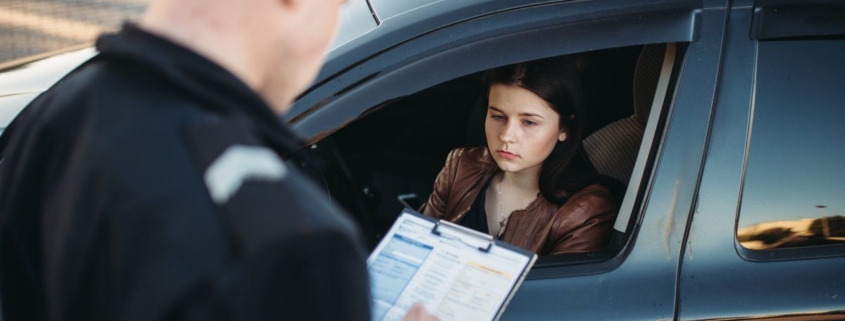 oliceman in uniform writes fine to female driver