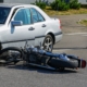 traffic accident, motorcycle collision with a car on city street