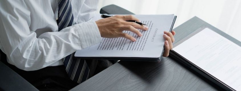 Lawyer reading legal document in office room