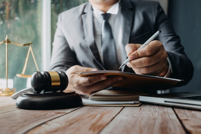 Attorneys reviewing contract and deposition paperwork in a law office