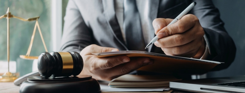 Attorneys reviewing contract and deposition paperwork in a law office