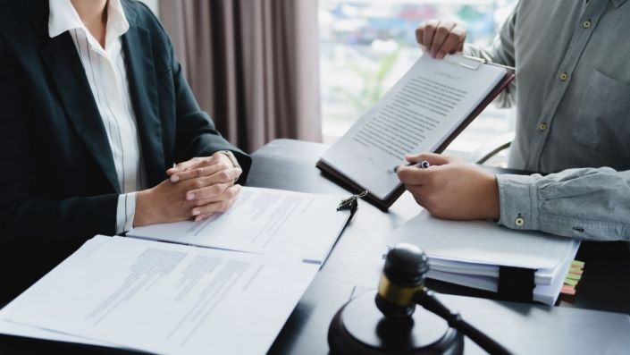 Lawyer signing a legal document next to a judge's gavel, representing a punitive damages claim in California